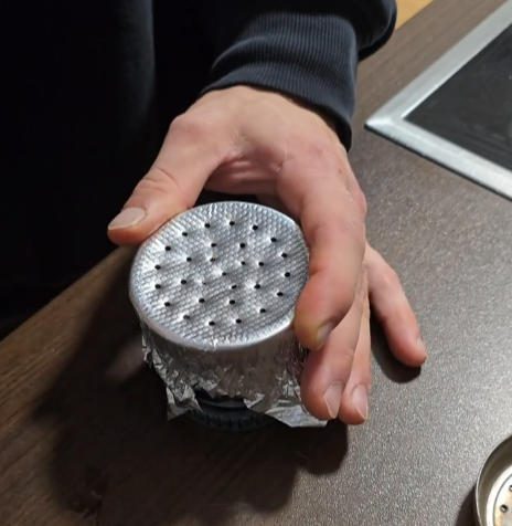 Close-up of even foil poking hole pattern showing correct perforation technique