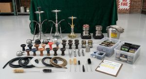 Full startup equipment set including hookahs, burners, and cleaning tools arranged for display